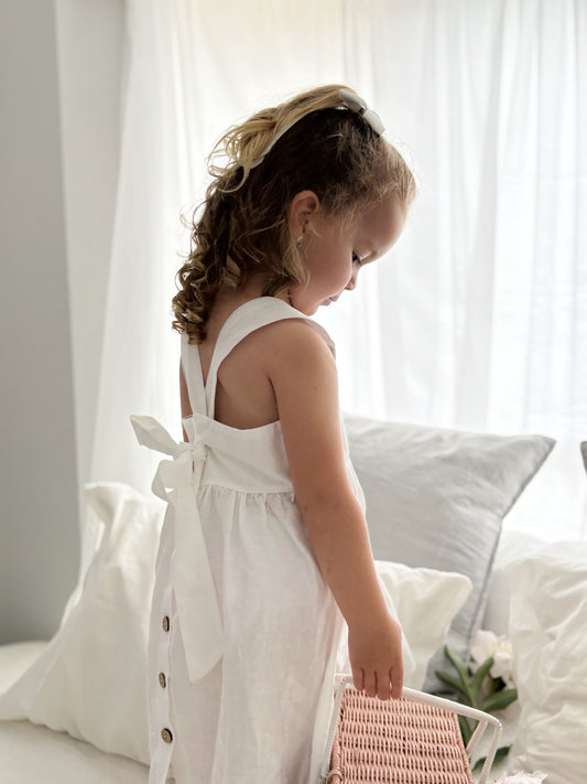 Milky Mae Amelia Dress made with a gentle linen/ cotton blend featuring delicate wooden buttons and an elegant tie bow feature