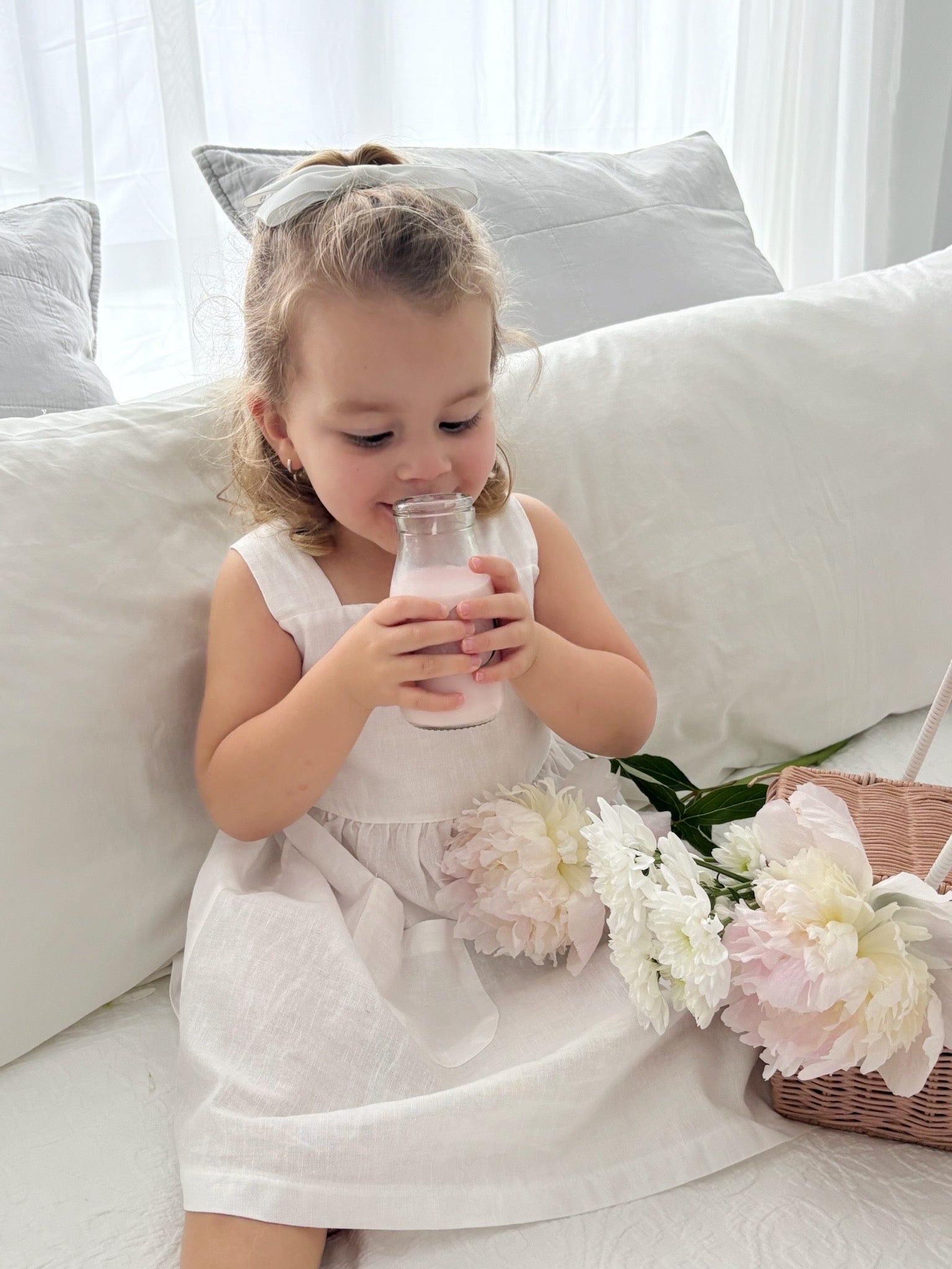Milky Mae Amelia Dress made with a gentle linen/ cotton blend featuring delicate wooden buttons and an elegant tie bow feature