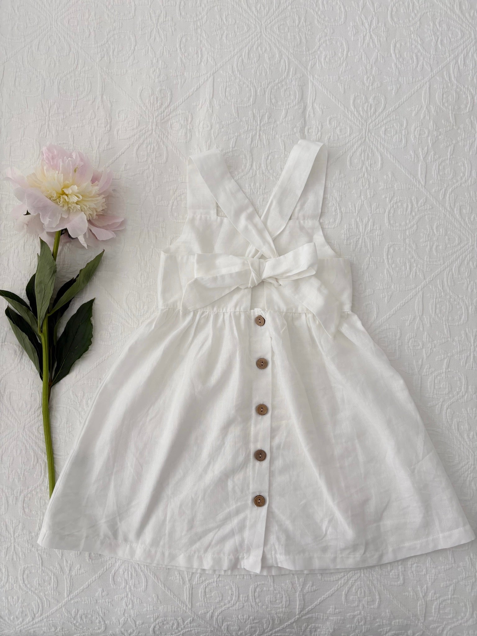 Milky Mae Amelia Dress made with a gentle linen/ cotton blend featuring delicate wooden buttons and an elegant tie bow feature