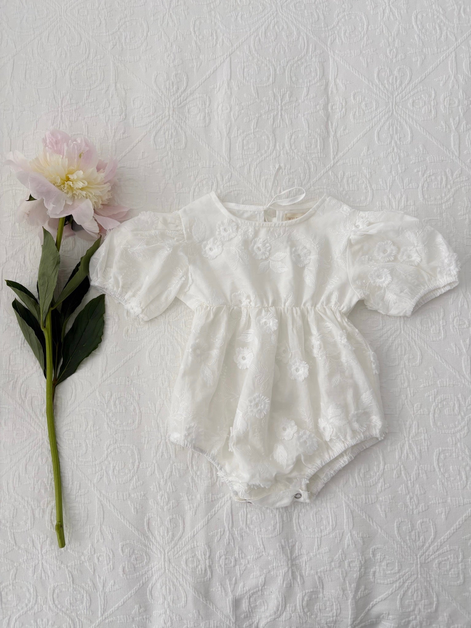 Milky Mae Elaina Romper in cotton fabric with delicate embroidered flowers