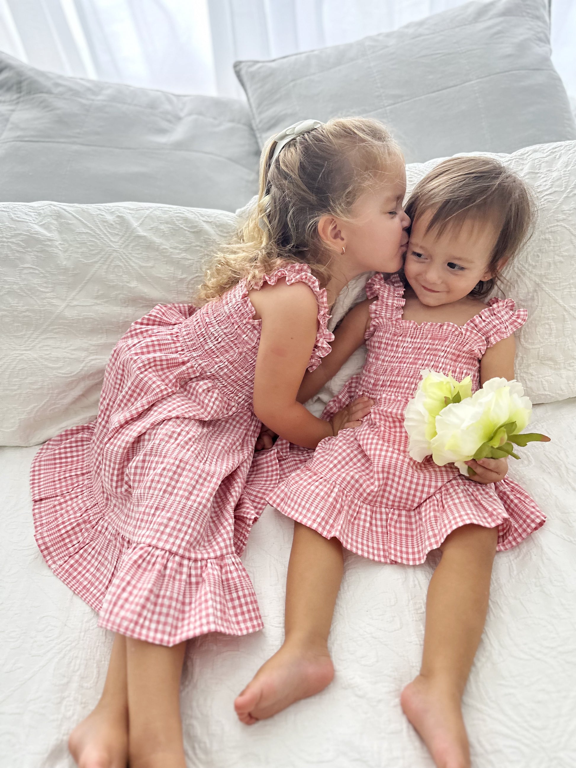 Milky Mae Sweetheart Sundress featuring delicate ruffle straps and a classic pink and white gingham pattern