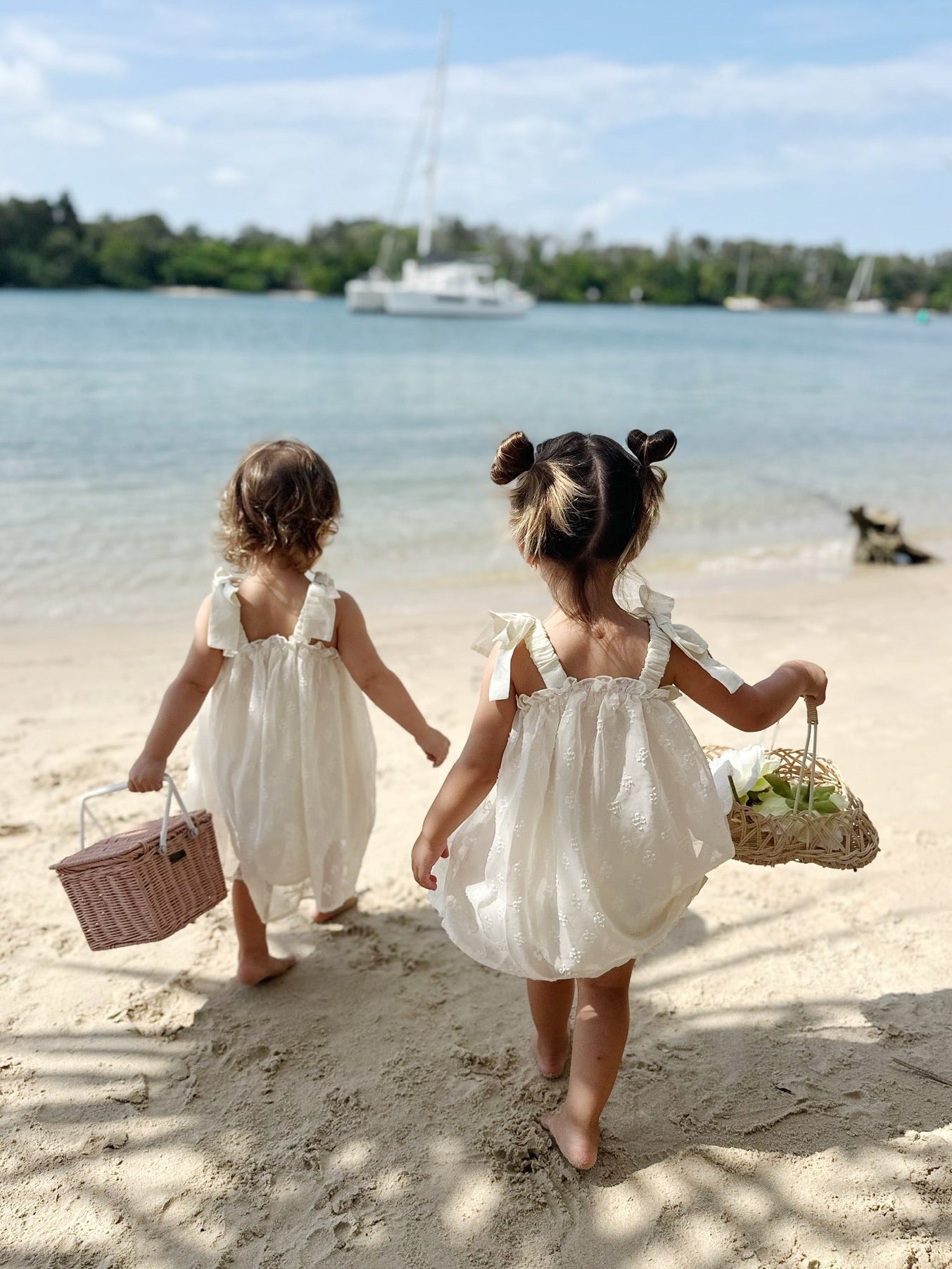 Milky Mae Buttercup Dress crafted in a soft cream hue and featuring a sheer polka-dot overskirt